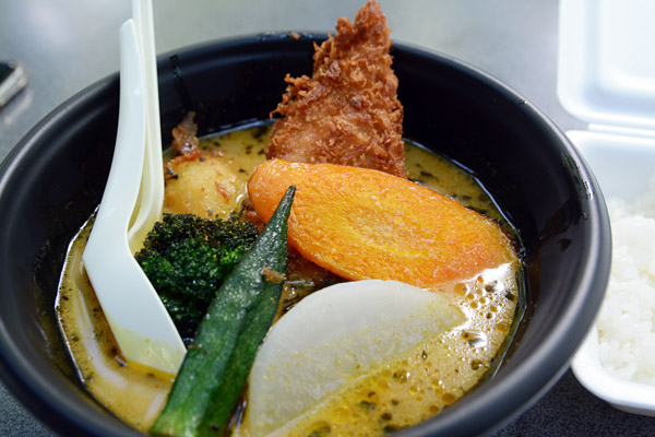 きました「フィッシュフライスープカレー」。フライは揚げたてでカリッとしてる。スープを一口、いいねー、こんなのフェスで食べられるなんて思ってもいなかった。よく見るとテントにはスパイスが大量に、、、マジだ、本気だぞポニピリカ!! ちなみに、私はお野菜の具の中では大根が一番好きです、合うんだよこれがーー
